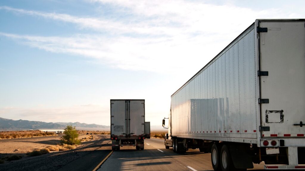 Illustration of a truck driver reviewing an ELD compliance alert after the device was removed from the FMCSA list.