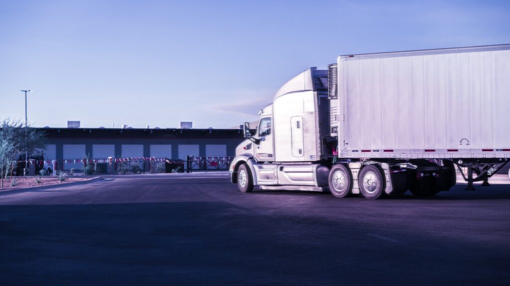 Use the LinkedIn article cover image or a compliant branded image showing commercial trucks, broker carrier selection, and DOT/FMCSA compliance review.