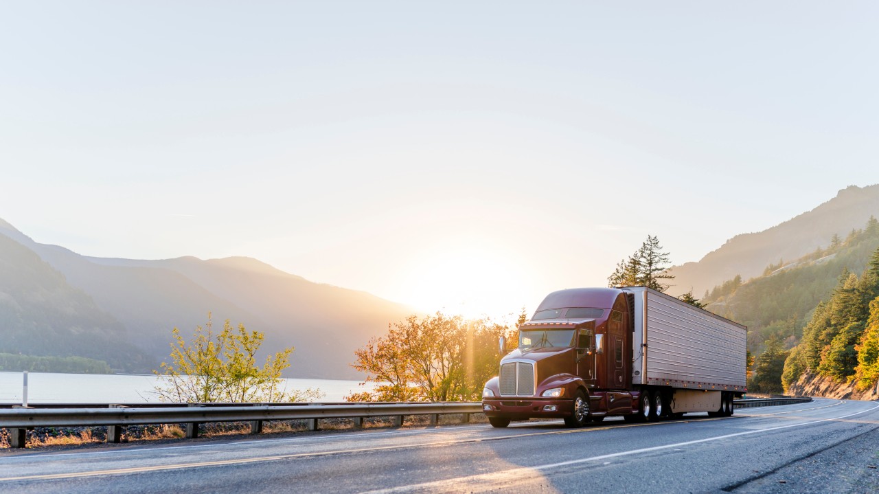Use a professional image of a commercial truck during a roadside inspection, DOT inspection checkpoint, or driver documentation review.